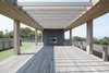 Modern home with Exterior, House Building Type, Wood Siding Material, Prefab Building Type, Flat RoofLine, and Green Roof Material. Roof deck with trellis above and outdoor fireplace beyond Photo 8 of North Fork Bluff House