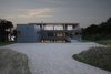 Modern home with Exterior, Wood Siding Material, House Building Type, Flat RoofLine, and Prefab Building Type. Front of the home at dusk Photo 10 of North Fork Bluff House