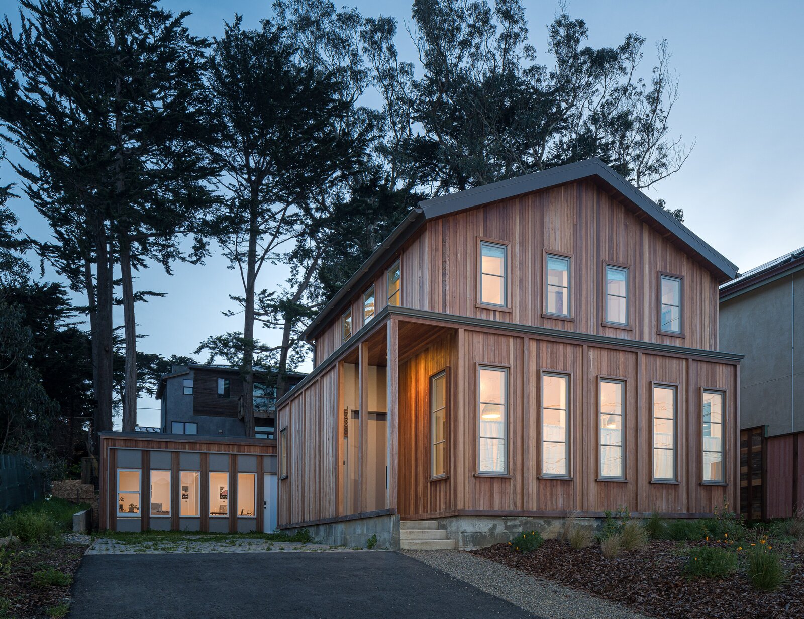The pitched roof upstairs is set back from the flat-roofed main floor, breaking up its mass. The detached rear garage serves as an office for Moshe and Wayne’s firm, Porter &amp; Erb Architects.