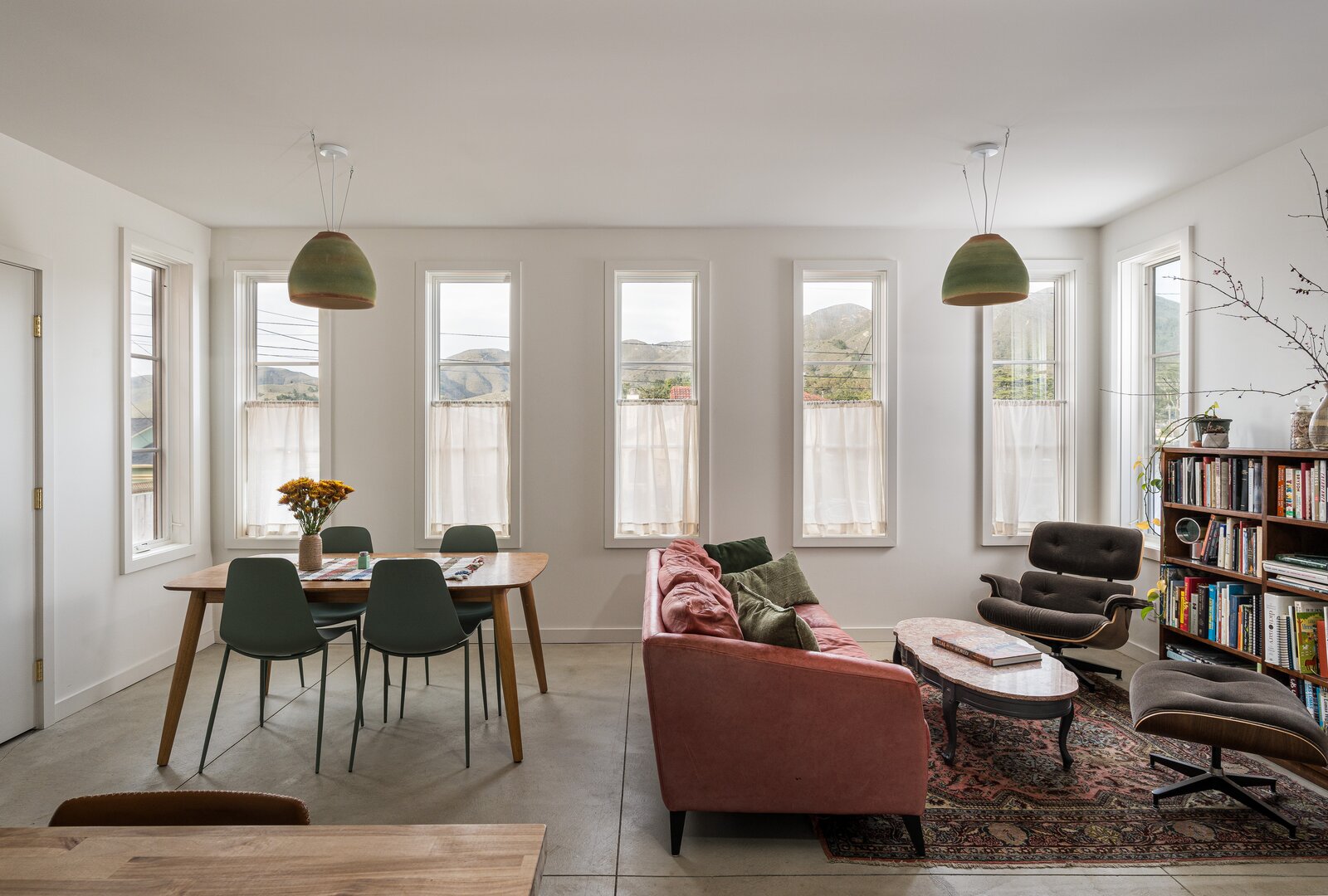 The great room, with views of Montara Mountain, is stocked with vintage furniture including an Eames chair.