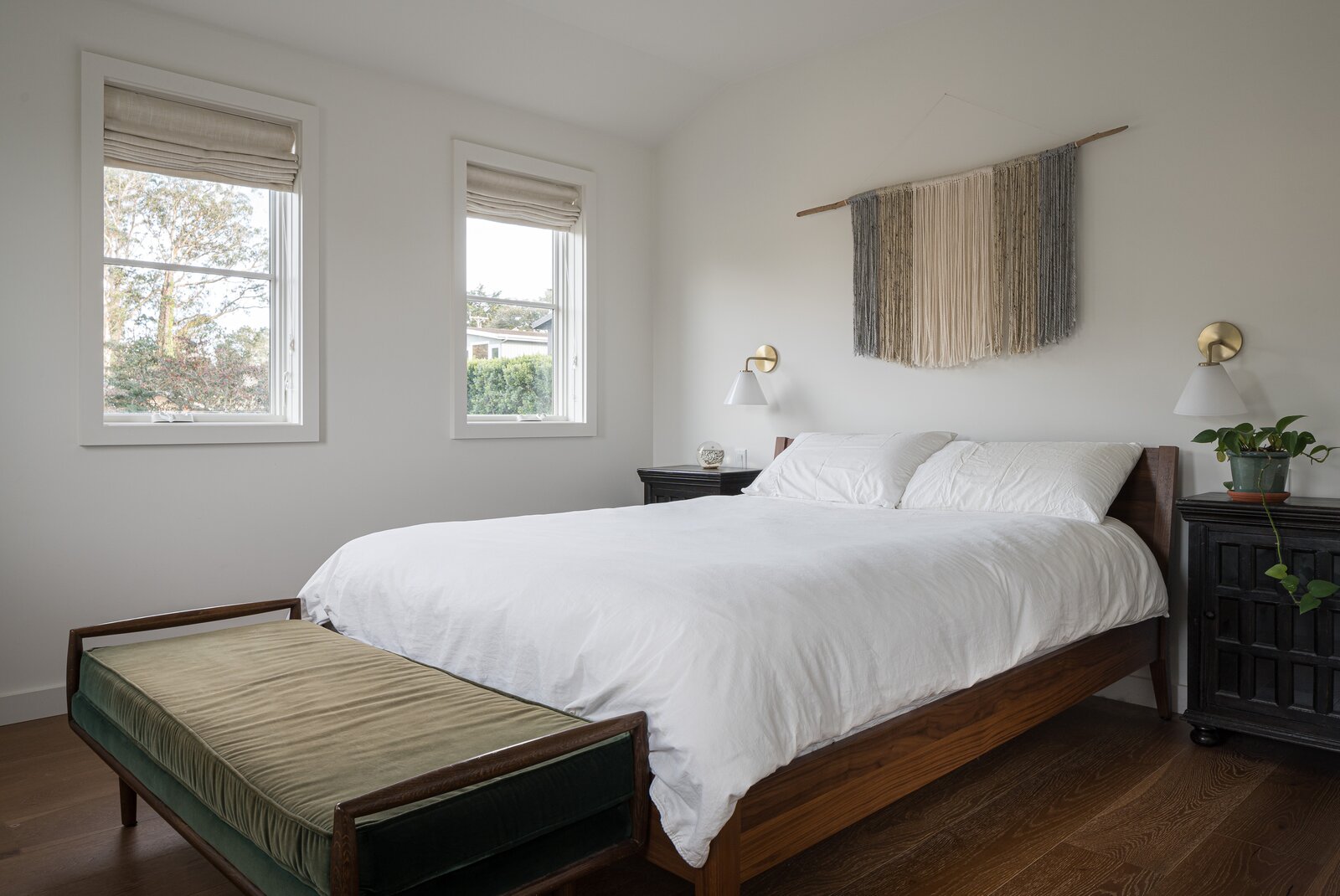 The master bedroom, its bed lined by vintaged nightstands.