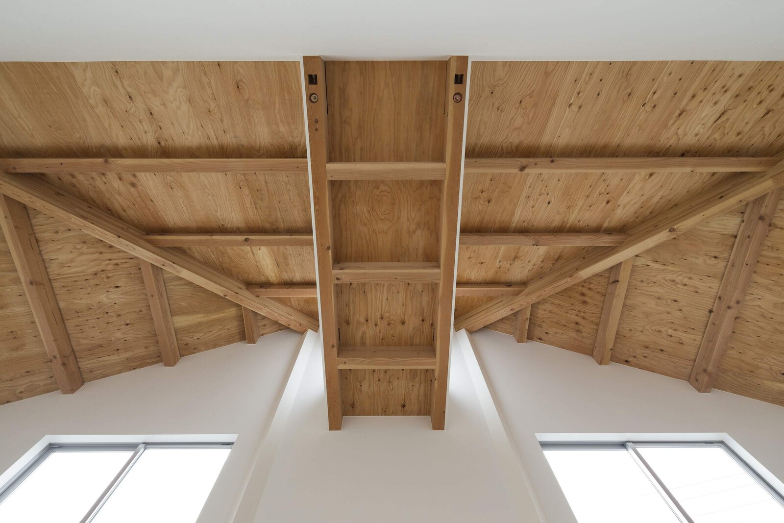 The home's ceilings are clad in plywood, which pair with the oak floors to add natural texture.
