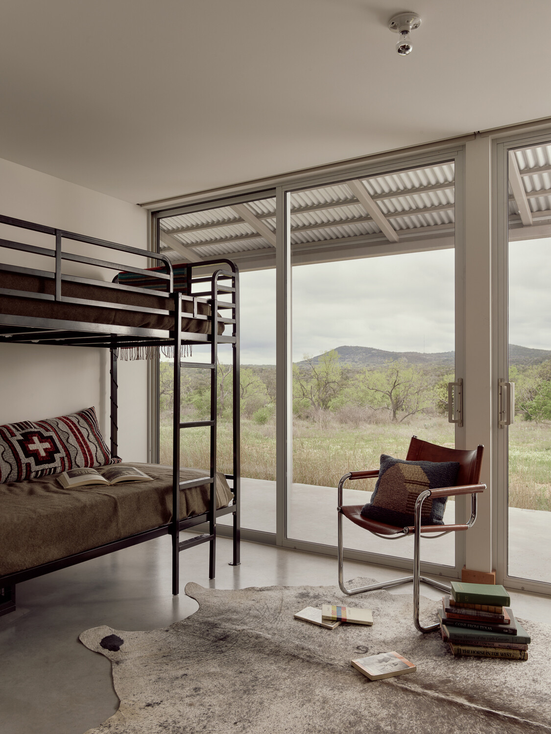 Both bedrooms, including this bunk room, feature the same sliding-glass doors as the living room and great room, allowing plenty of natural light.