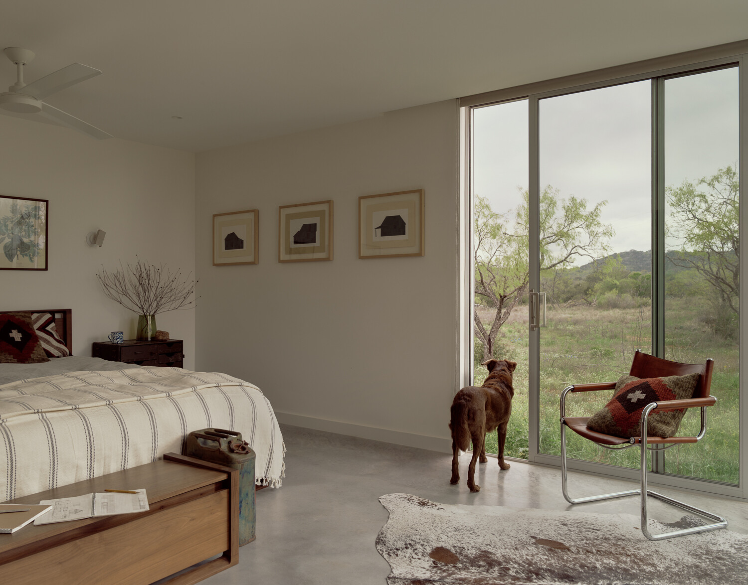 The master bedroom has sliding-glass doors on two sides, encouraging natural ventilation throughout the house.