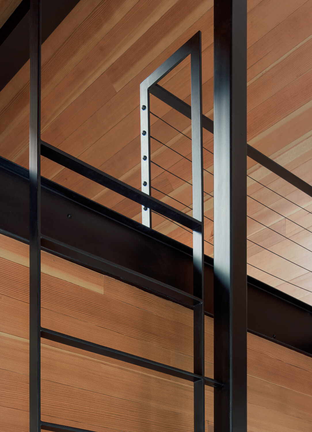 Above the bunk room, a built-in ladder leads to an additional loft-style sleeping area.