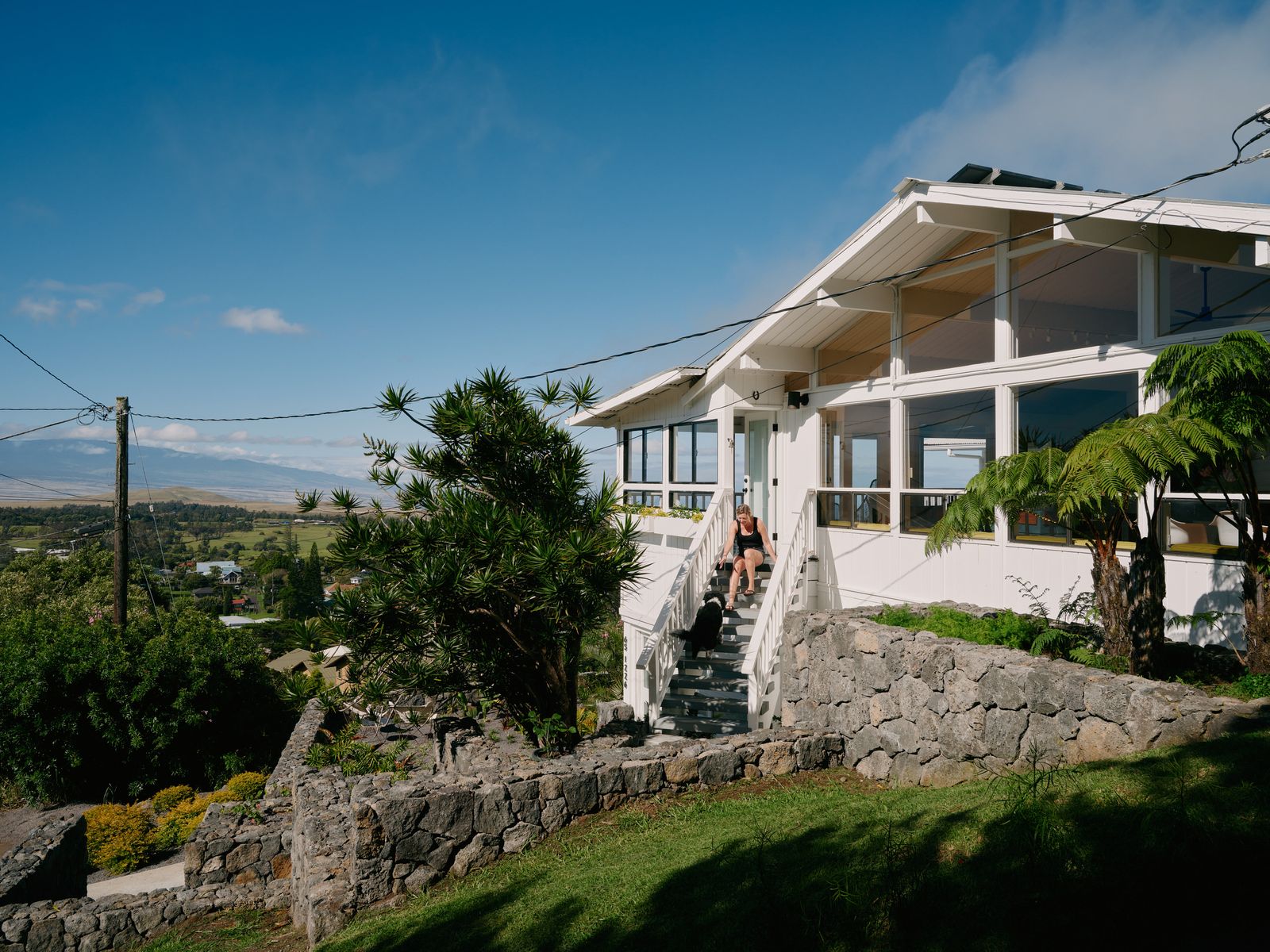 The house enjoys panoramic views of the Pacific Ocean and three volcanoes. His renovation included new stone cards in various spots outside.