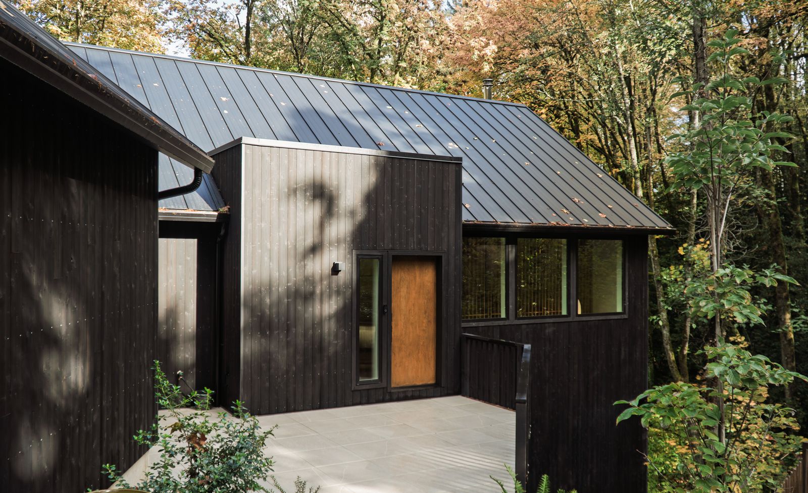 The house is clad with shou sugi ban-treated cedar siding.