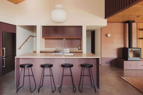Josh Kjenner's design devoted a majority of the square footage to ground-floor public areas: a combined living-dining-kitchen area that's conducive to entertaining. The kitchen stools are by Bouclair.
