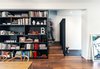 Modern home with Storage Room, Shelves Storage Type, and Under Stairs Storage Type. Upon entry into the vestibule, visitors are greeted by a textured black wall, stopping short of the ceiling and allowing for a glimpse up the stair Photo 3 of Contrast House