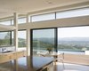 Modern home with Kitchen, Medium Hardwood Floor, Wood Counter, Dishwasher, White Cabinet, Engineered Quartz Counter, Undermount Sink, Wood Cabinet, Recessed Lighting, Wall Lighting, and Wine Cooler. Ridge House Photo 7 of Ridge House
