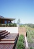 Modern home with Outdoor, Raised Planters, Wood Fences, Wall, Slope, Walkways, Landscape Lighting, Retaining Fences, Wall, Grass, Trees, Concrete Fences, Wall, Large Pools, Tubs, Shower, Concrete Pools, Tubs, Shower, Wood Patio, Porch, Deck, Horizontal Fences, Wall, Large Patio, Porch, Deck, Back Yard, Swimming Pools, Tubs, Shower, Shrubs, and Garden. Ridge House Photo 15 of Ridge House