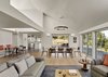 Modern home with Dining Room, Ceiling Lighting, Storage, Bench, Chair, Table, Ceramic Tile Floor, Pendant Lighting, Medium Hardwood Floor, Wall Lighting, Recessed Lighting, Gas Burning Fireplace, Shelves, and Lamps. Orchard House Interior Photo 6 of Orchard House