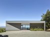 Modern home with Exterior, Wood Siding Material, House Building Type, and Flat RoofLine. Entry drive looking through courtyard to views beyond. Photo of Box on the Rock