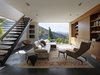 Modern home with Living Room, Chair, Rug Floor, Sofa, Bookcase, End Tables, Storage, Recessed Lighting, and Sectional. The original home occupies a prominent hilltop overlooking Silicon Valley and faces into the pristine rolling hills of a nature preserve at the end of the house receiving the new addition. Taking cues from dominant natural elements of the surrounding densely wooded hillside – boulders, bark, and leaves – SaA created a two-story addition with the visual weight needed to anchor the long axis of the extended original house. Against this, the architects balanced steel-framed stair treads and awnings that cantilever from minimal structural supports as if leaves from a slender branch. Photo of Shou Sugi Ban House
