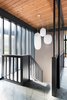 Modern home with Staircase, Wood Railing, and Stone Tread. The midcentury light fixtures blend well with the original slate floors and woodwork. Photo of Hillside Midcentury