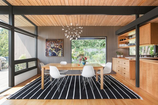 The dining room is where the young family gathers to share a meal and play games. 