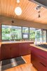 Modern home with Kitchen, Laminate Cabinet, Pendant Lighting, Colorful Cabinet, Wood Counter, Medium Hardwood Floor, Drop In Sink, Rug Floor, and Cooktops. The team inserted custom-designed kitchen cabinets—built by local manufacturer Beech Tree Woodworks—to add a pop of color to the kitchen.
Photo 7 of Hillside Midcentury