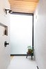 The frosted floor-to-ceiling windows in the bathroom helped to brighten up the space in the corner of the house. Photo 11 of Hillside Midcentury modern home