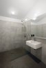 Modern home with Bath Room, Wall Mount Sink, Open Shower, Concrete Wall, and Concrete Floor. A clean and simple bathroom add to the modern feel of the space. Photo 5 of Stable Conversion