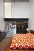 Modern home with Bedroom and Concrete Floor. A lightweight enclosure of perforated steel defines a new closet space while maintaining the openness of the original layout. The intention in the newly converted loft upstairs was the opposite; the formerly exposed loft space was closed off with a translucent 3Form wall panel and a framed wall to create a guest room and additional storage. Photo 6 of Capitol Hill Loft