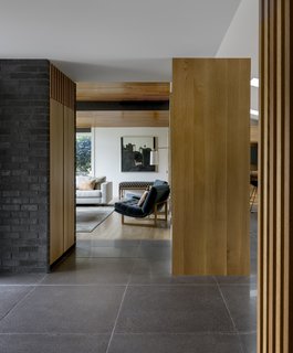 After a lifetime of random remodels, this 1959 Northwest contemporary ranch home in Seattle's Madison Park neighborhood finally received an overhaul that makes it shine. Seattle–based SHED Architecture & Design undid the outdated layers, updating and modernizing the home while paying respect to its original midcentury charm. The renovation juxtaposes light and dark elements—Douglas fir is set against dark bricks and oversized concrete floor tiling. This convention aligns with the home's original material palette while adding a contemporary vibe.