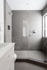 Modern home with Bed, White Cabinet, Night Stands, Ceramic Tile Backsplashe, Coffee Tables, Table, Sofa, Wood Railing, End Tables, Bar, Porcelain Tile Wall, Wood Tread, Metal Railing, Porcelain Tile Floor, Cable Railing, Carpet Floor, Undermount Sink, Open Shower, Two Piece Toilet, and Pendant Lighting. Master Bath Photo 19 of Tahoe Lakefront