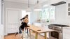Modern home with Kitchen, Pendant Lighting, Medium Hardwood Floor, Range, White Cabinet, and Marble Counter. Kitchen Photo of Land Park Drive