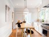 Modern home with White Cabinet, Light Hardwood Floor, Ceramic Tile Backsplashe, Marble Counter, Pendant Lighting, Drop In Sink, Kitchen, Range Hood, and Range. Kitchen Photo 4 of Land Park Drive
