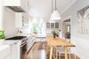 Modern home with Marble Counter, White Cabinet, Light Hardwood Floor, Pendant Lighting, Wood Railing, Wood Tread, Range Hood, Ceramic Tile Backsplashe, Recessed Lighting, Kitchen, Range, and Drop In Sink. Kitchen Photo 8 of Land Park Drive