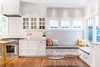 Modern home with Marble Counter, Light Hardwood Floor, Ceramic Tile Backsplashe, Wood Tread, Range, Wood Railing, White Cabinet, Drop In Sink, Pendant Lighting, Recessed Lighting, Range Hood, and Kitchen. Kitchen Photo 9 of Land Park Drive