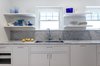 Modern home with Marble Counter, Light Hardwood Floor, Stone Slab Backsplashe, Ceiling Lighting, White Cabinet, Recessed Lighting, Cooktops, and Kitchen. Kitchen Photo 7 of Jensen