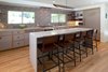 Modern home with Engineered Quartz Counter, Colorful Cabinet, Light Hardwood Floor, Wood Cabinet, Wall Oven, Ceramic Tile Backsplashe, Pendant Lighting, Recessed Lighting, Refrigerator, Cooktops, Wine Cooler, Range Hood, Kitchen, Undermount Sink, and Dishwasher. Kitchen Photo 2 of Birchwood