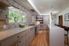 Modern home with Engineered Quartz Counter, Colorful Cabinet, Ceramic Tile Backsplashe, Light Hardwood Floor, Wood Cabinet, Pendant Lighting, Wall Oven, Recessed Lighting, Refrigerator, Cooktops, Range Hood, Undermount Sink, Wine Cooler, Dishwasher, and Kitchen. Kitchen Photo 3 of Birchwood