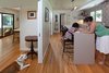 Modern home with Engineered Quartz Counter, Light Hardwood Floor, Ceramic Tile Backsplashe, Sofa, Coffee Tables, Wood Burning Fireplace, Standard Layout Fireplace, Table, Chair, and Kitchen. Kitchen Photo 8 of Birchwood