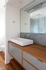 Modern home with Medium Hardwood Floor, Enclosed Shower, Vessel Sink, Freestanding Tub, Wood Counter, Corner Shower, Ceramic Tile Wall, Ceiling Lighting, Recessed Lighting, Wall Lighting, One Piece Toilet, and Bath Room. Master Photo 3 of South Land Park