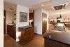 Modern home with Front Yard, Large Patio, Porch, Deck, Large Pools, Tubs, Shower, Raised Planters, Shrubs, Grass, Horizontal Fences, Wall, Landscape Lighting, Dark Hardwood Floor, Wood Cabinet, Engineered Quartz Counter, Recessed Lighting, Ceramic Tile Backsplashe, Dishwasher, Wall Oven, Refrigerator, Cooktops, Range Hood, Undermount Sink, and Kitchen. Kitchen Photo 5 of Sherwood
