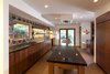 Modern home with Large Pools, Tubs, Shower, Raised Planters, Shrubs, Grass, Front Yard, Large Patio, Porch, Deck, Landscape Lighting, Dark Hardwood Floor, Horizontal Fences, Wall, Wood Cabinet, Engineered Quartz Counter, Ceramic Tile Backsplashe, Recessed Lighting, Dishwasher, Refrigerator, Wall Oven, Cooktops, Range Hood, Undermount Sink, and Kitchen. Kitchen Photo 6 of Sherwood