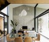 Modern home with Living Room, Concrete Floor, Chair, Pendant Lighting, End Tables, Shelves, and Sofa. Overall living area with dual aspects and connections to an interstitial garden court and rear landscaped yard beyond its concrete terrace Photo 19 of Binary House