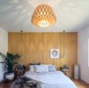 Modern home with Pendant Lighting. An oversized geometric pendant is expertly matched to the wall behind the bed for a simple, cohesive, and impactful look. Photo 20 of Binary House