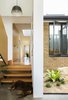 A look at the interface between old and new through the original yellow-brick dwelling. Photo 11 of Binary House modern home