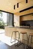 Modern home with Kitchen, Concrete Floor, Wood Cabinet, Ceiling Lighting, Engineered Quartz Counter, and Undermount Sink. A kitchen view and its connection to the rear terrace and landscape beyond Photo 12 of Binary House