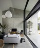 Modern home with House Building Type, Living Room, Pendant Lighting, Concrete Floor, Sofa, Chair, Media Cabinet, and Rug Floor. A volumetrically expansive double-height living area serves as a generously proportioned "garden room," capturing vast sky and landscape views. Photo 2 of Binary House