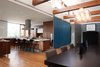 DECA Architecture designed a moveable wall to create a guest area when closed, and join the space with the kitchen and dining room when open. Photo 2 of The CYRK Building modern home