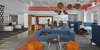 Another breakout space and work lounge features more Niche modern orb pendants. Our signature Gray glass helps to balance out the bold blues and oranges featured prominently throughout the interior, which beautifully reflect HubSpot's branding. Photo 4 of HubSpot Offices modern home