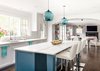 Modern home with Kitchen, Medium Hardwood Floor, Pendant Lighting, Marble Counter, and White Cabinet. Two Condesa Stamen hang above the eat-in kitchen island. The burst of brightness from the blue glass pendants complement the soft accents of the island cabinetry and curtains. The blue stands out against an otherwise neutral palette of varying tones of whites and grays, adding a pop to this light and airy kitchen. Photo 3 of Clark