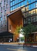 Modern home with Exterior and Glass Siding Material. Inside, the hotel’s lobby is marked by a massive living wall created by landscape architecture firm Harrison Green. Many of the furnishings for the space are made by Brooklyn artisans and were crafted using locally sourced materials. "There’s a large pine table made with reclaimed pine beams from the Domino Sugar Factory in Brooklyn," says designer Waad El Hadidy, of Starwood Capital Group, the company that developed the hotel with Toll Brothers City Living. "The art piece behind the reception desk is by Brooklyn artist Jarrod Beck. It’s made with rubber roof membrane he collected in Utica, New York, after a tornado destroyed homes there in 2014." Another artwork—comprised of 6,000 pounds of hammered and shaped obsidian rocks and hand-dyed, rust-colored rope—by Rachel Mica Weiss is situated near the bottom of the lobby’s main staircase. Photo 3 of 1 Hotel Brooklyn Bridge