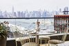 Modern home with Dining Room, Chair, and Table. Expansive views of the Manhattan skyline are available from many of the rooms and from Summerly, the rooftop bar and restaurant. Photo 3 of The Hoxton Williamsburg