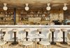 Modern home with Dining Room, Bar, Pendant Lighting, Chair, Accent Lighting, Table, Cement Tile Floor, and Stools. The bar area of Summerly, the rooftop bar and restaurant, displays brass stools upholstered with floral-patterned fabric, geometric tile, and cafe tables and chairs. Photo 8 of The Hoxton Williamsburg