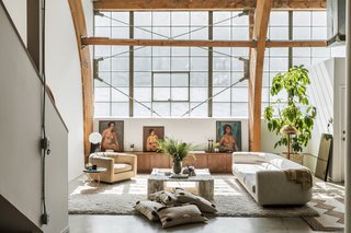 The designer set a collection of figure paintings she purchased at a Pasadena, California, flea market on top of a wood credenza she designed for the living room. The marble table is a piece by Gae Aulenti she purchased at auction.