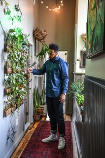 Carter waters his living wall. 